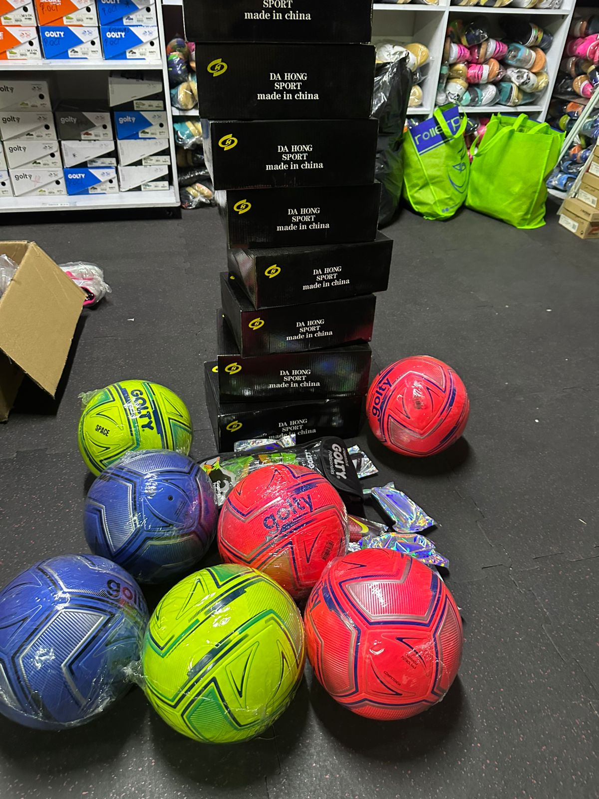 New soccer balls and stacked shoe boxes