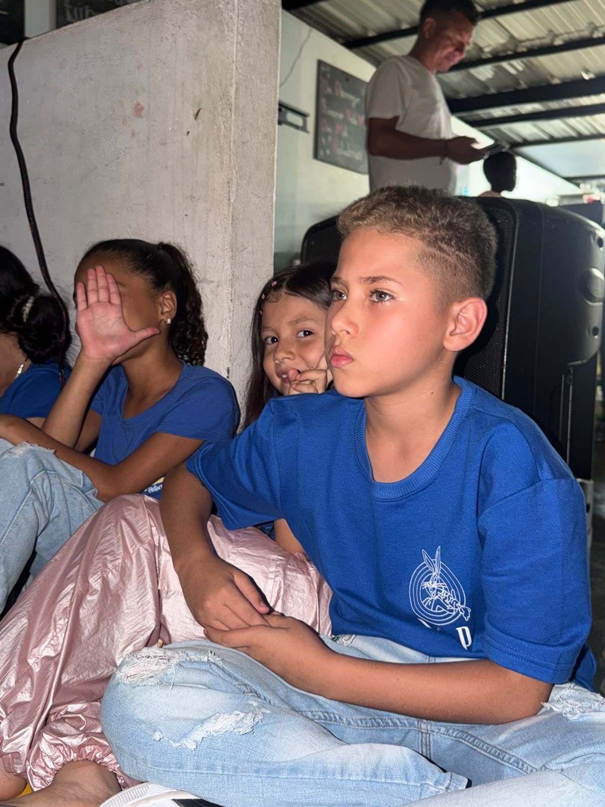 Children sitting with popcorn cups