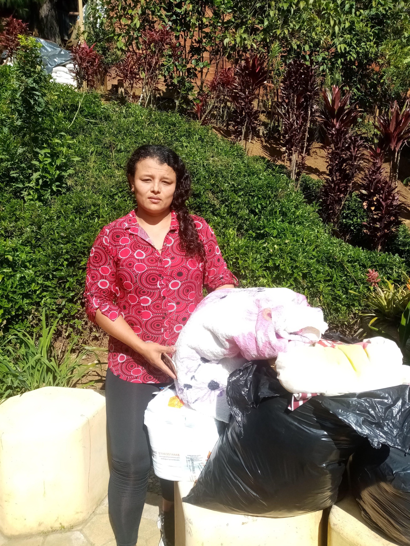 Woman holding bags of donated clothing