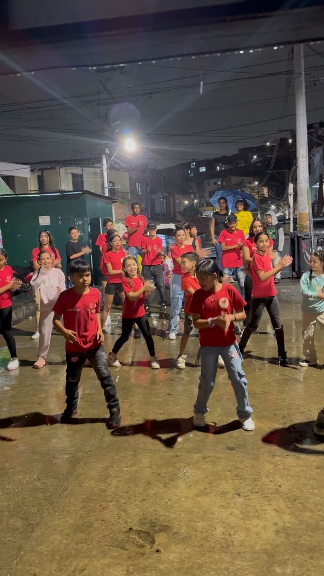 A large crowd of children in red shirts gathered on a street
