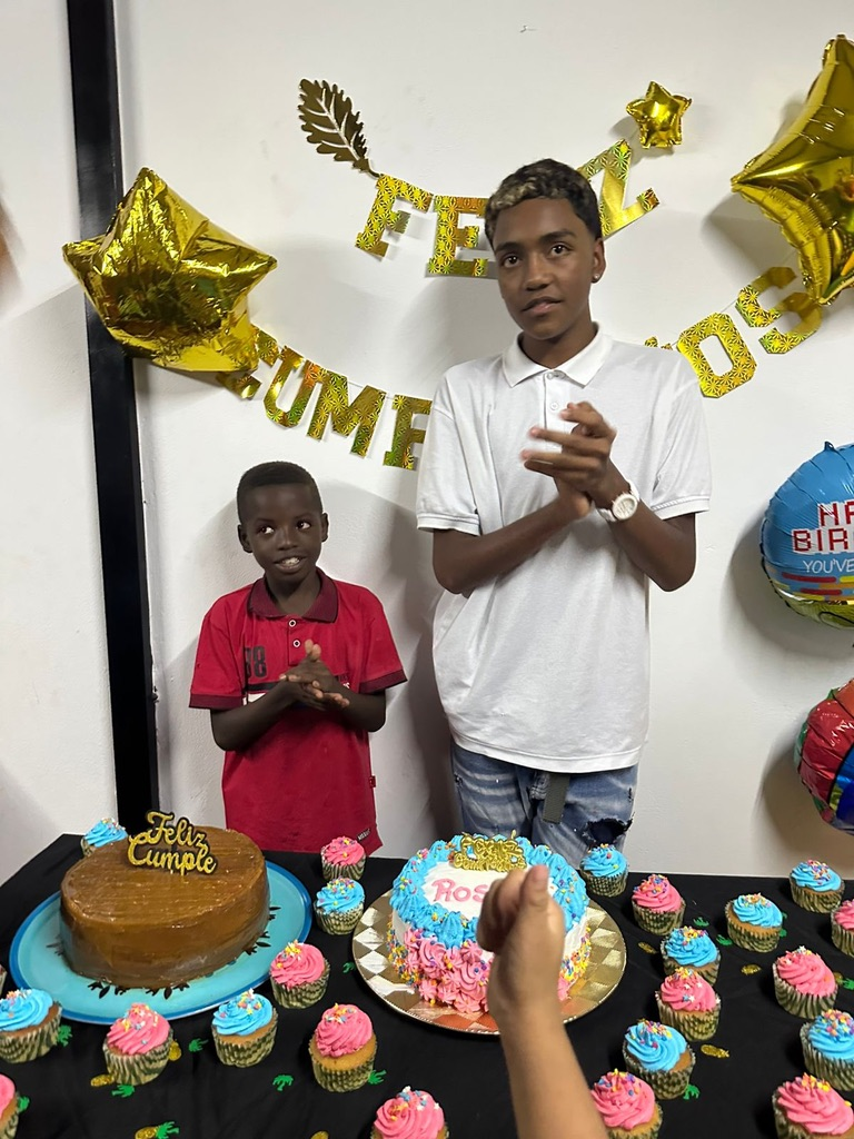 A birthday celebration with cake and cupcakes.