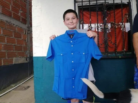 A neighbor holds up a donated shirt.