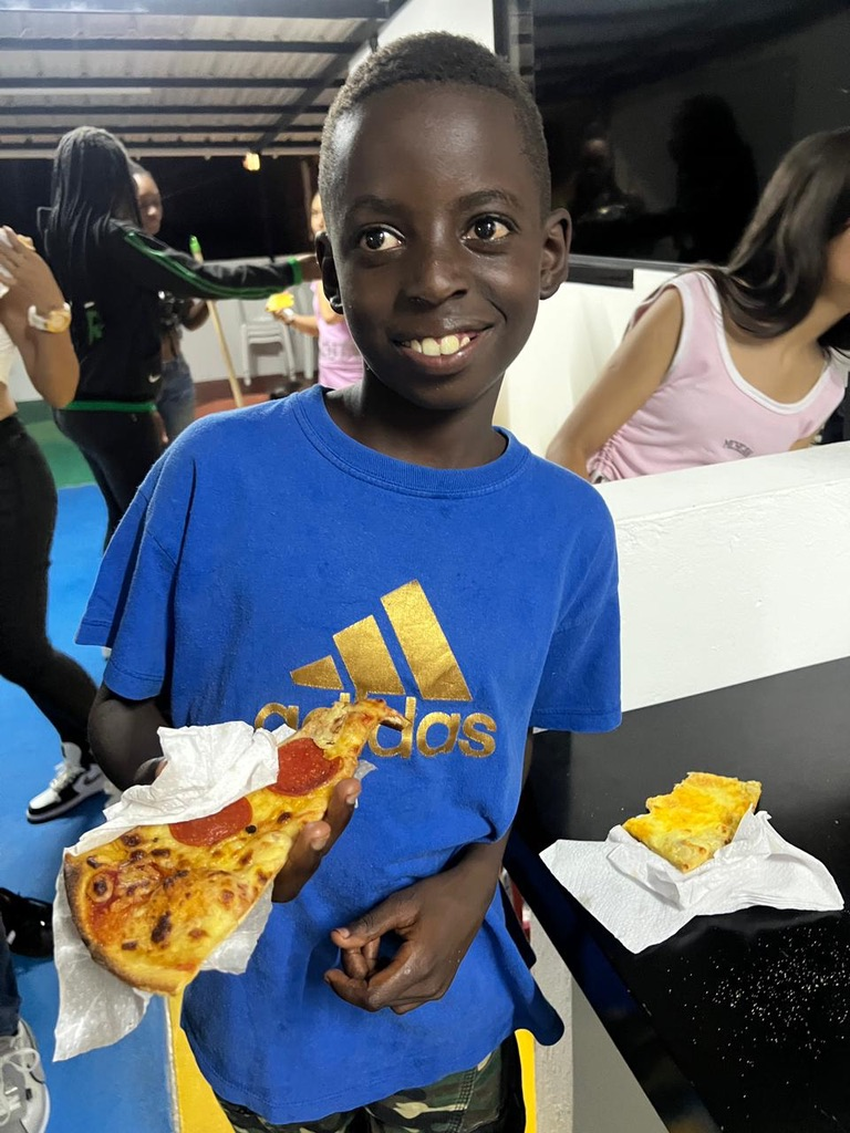 A big smile and a slice of pizza.