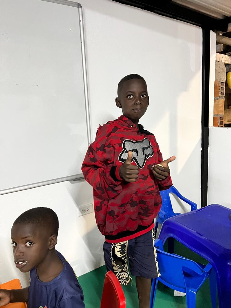 Two thumbs up in a red hoodie.
