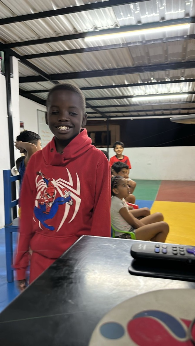 A boy in a red sweatshirt at the center.