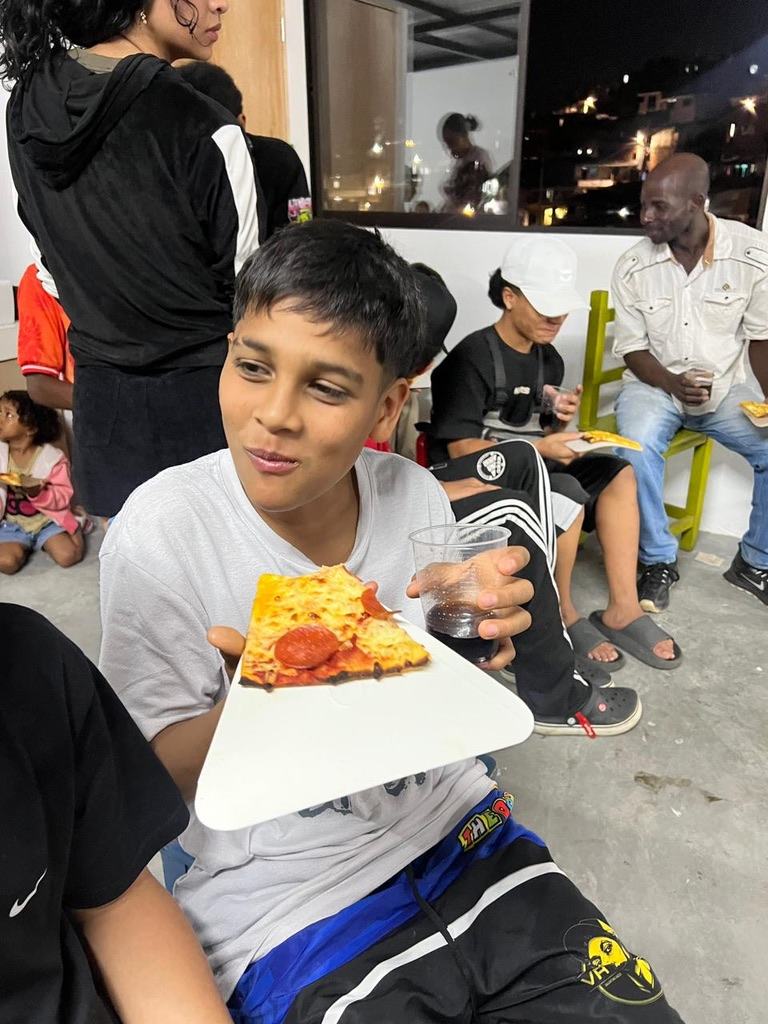 A boy shows off his slice.