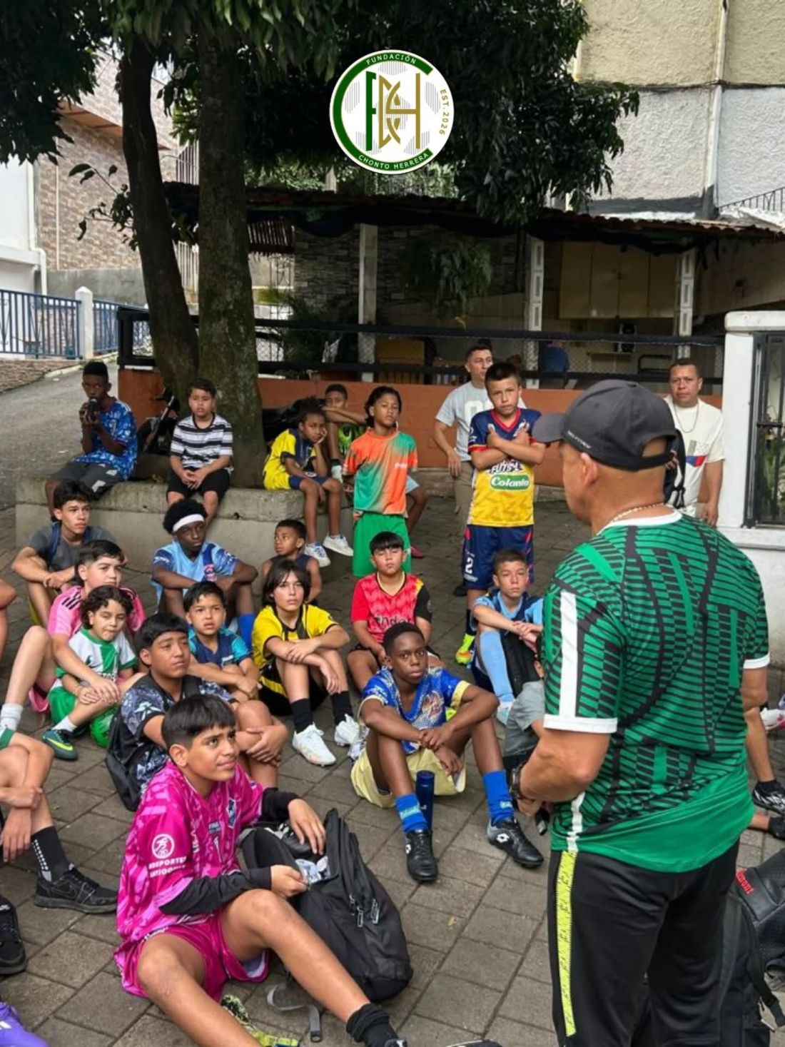 Young players in Medellín listening to a team talk