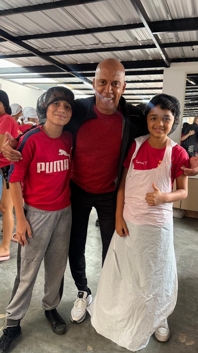 Coach Chonto with two young friends in Medellín, October 2026.