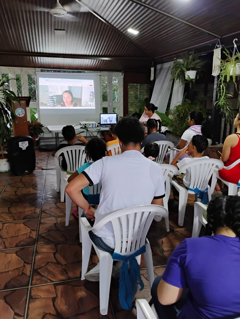 The teacher appears on the projector for a lesson in the Dominican Republic.