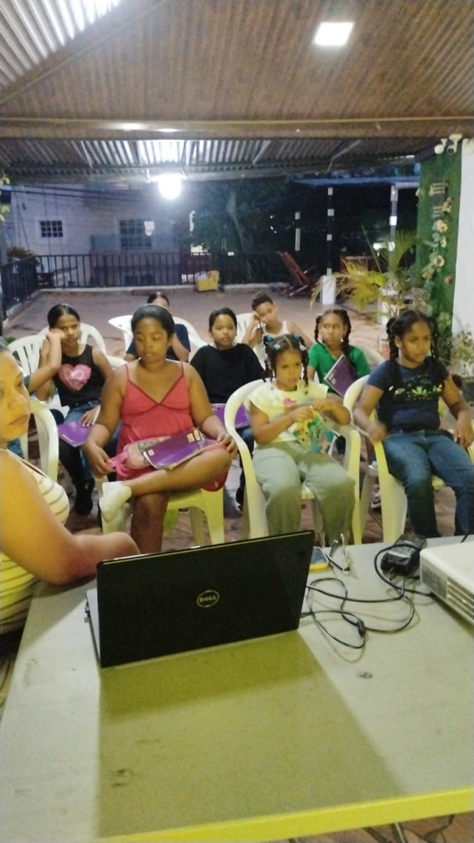 An evening class gathered around the laptop.
