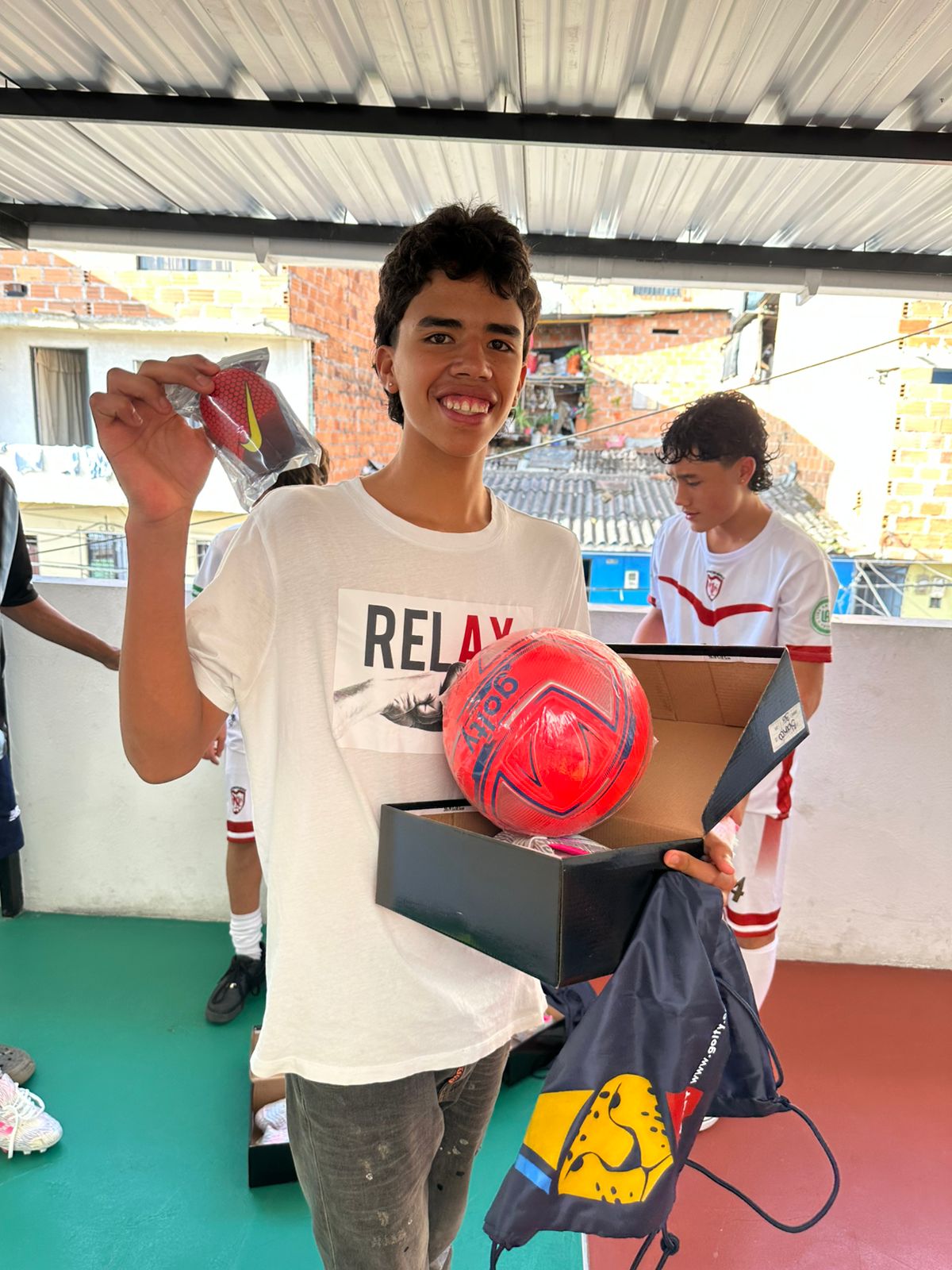 Young man holding a new soccer ball and a gear box
