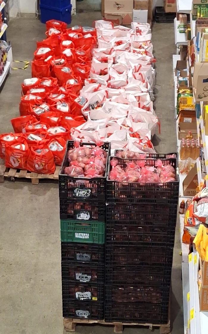 Bags of food and fresh produce for families in need.