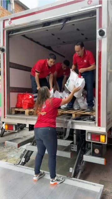 Volunteers unload bags of food for families in need.