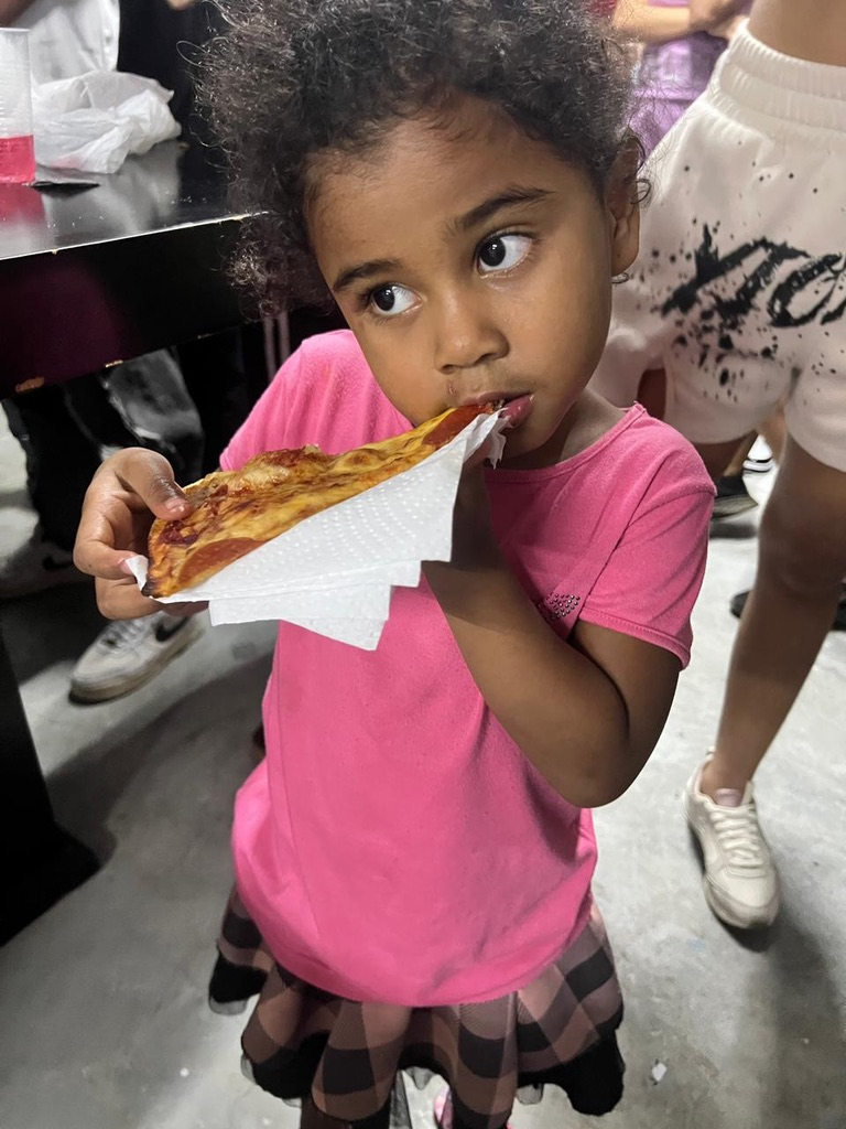 A girl enjoys her pizza.