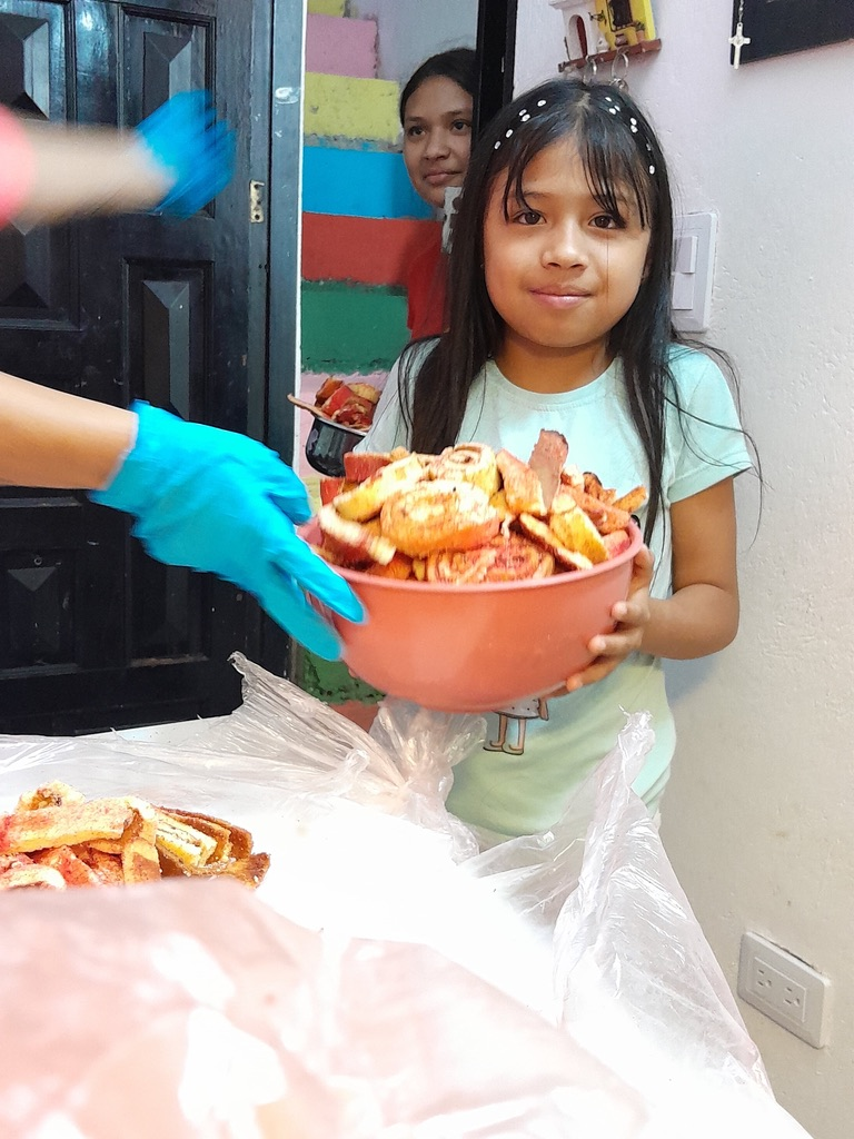 Serving up a fresh batch of food for the children.