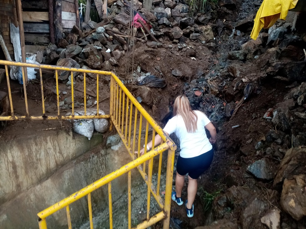 Volunteers reach homes damaged by the landslide.