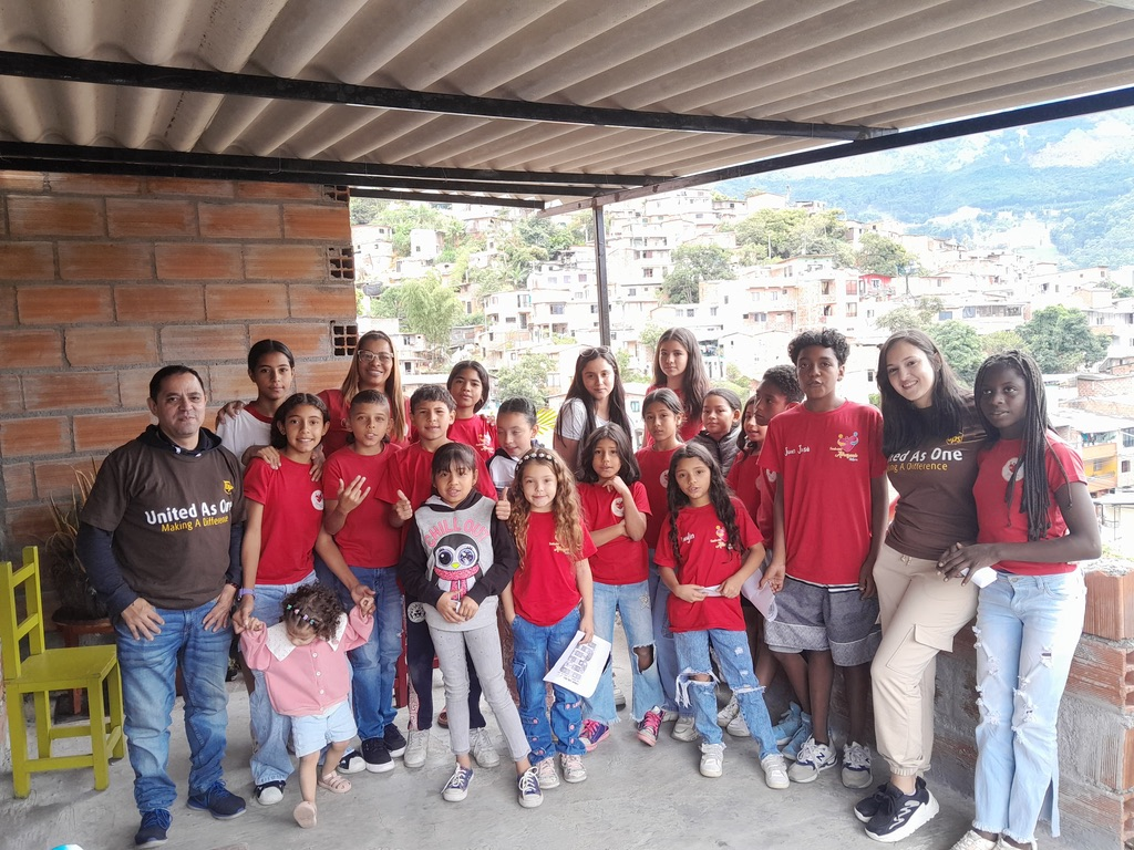 Children and volunteers together above the hillsides of Medellín.