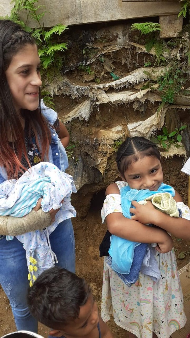 A mother and daughter with donated clothing.