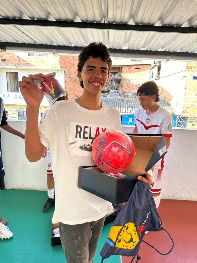 A young player with his new soccer ball and gear.