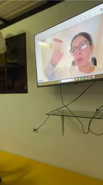 The teacher joins by video for a virtual English class.