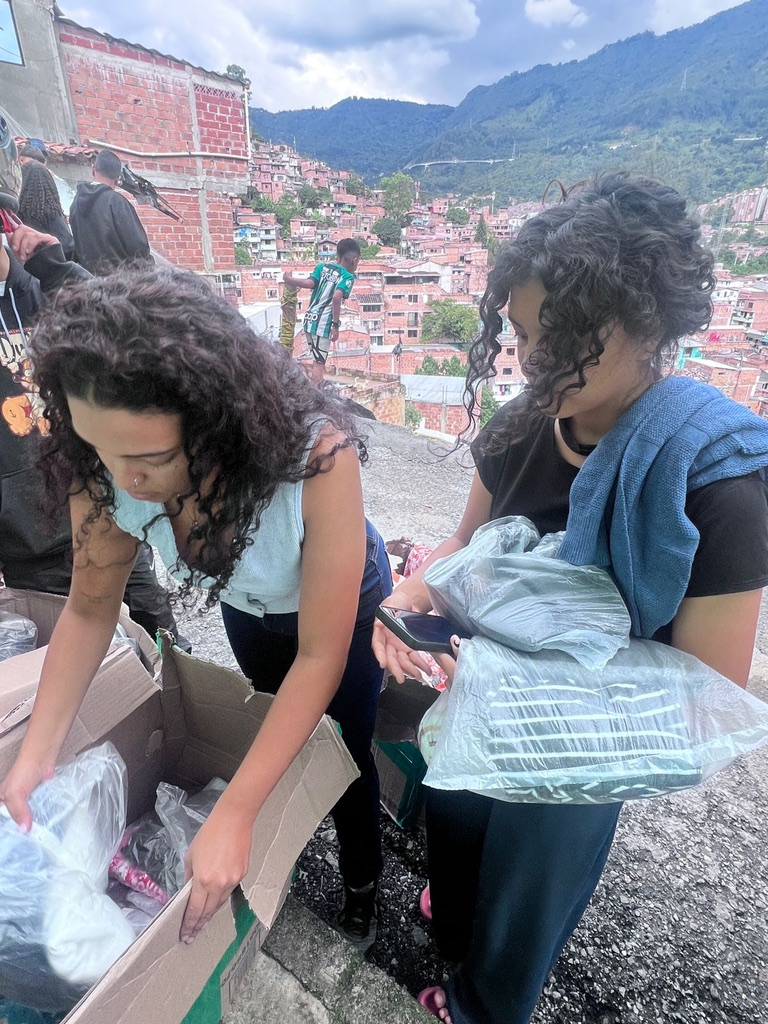 Volunteers sort donated clothing in the hills of Medellín.