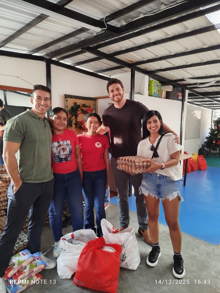 Volunteers with the children and their gifts.