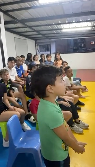 A young student stands up during a virtual English class in the Dominican Republic.